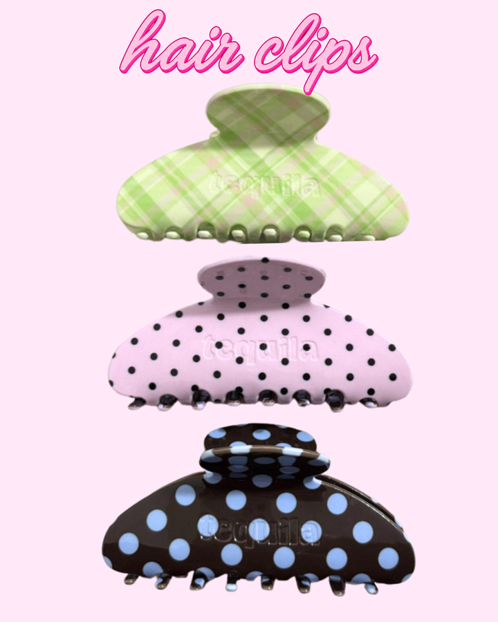 Three claw-style hair clips are shown vertically on a light pink background with the words &