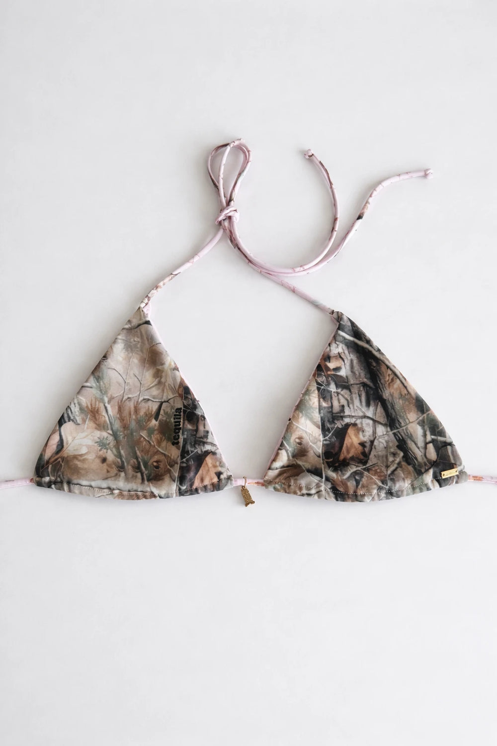 Triangle bikini top with brown and green camouflage print and thin pink adjustable straps laid flat on white background