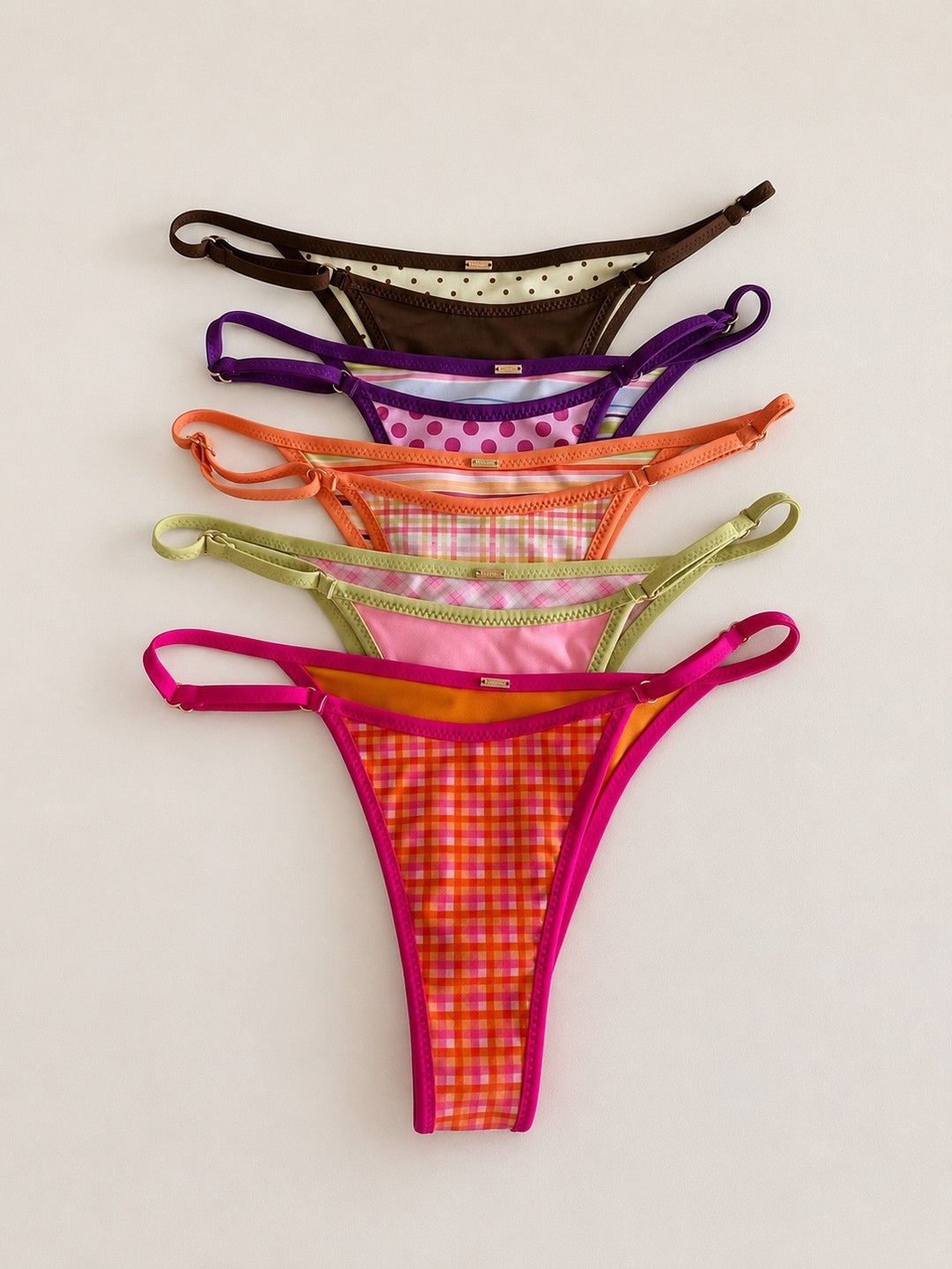 Five colorful thongs arranged on a light background