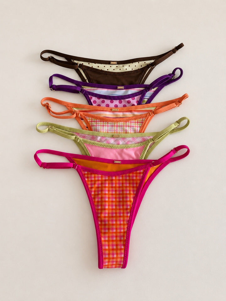 Five colorful thongs arranged on a light background