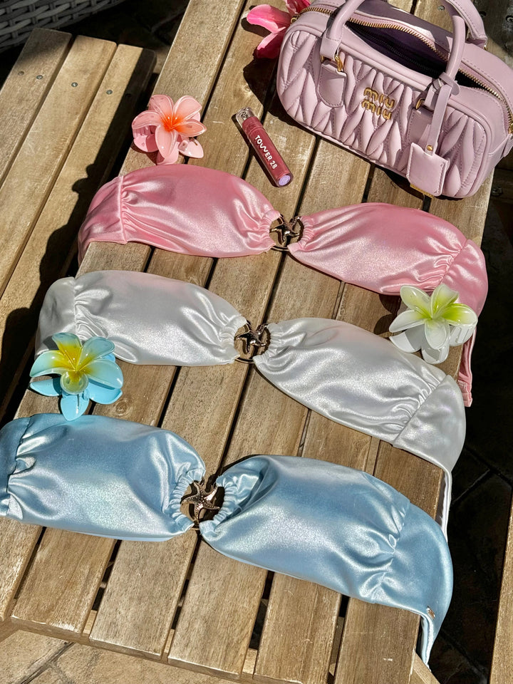 Tequila Swim Mia Bandeau Top in Sand Dollar, Monna, Starfish displayed flat lay on wooden deck